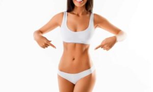 smiling woman pointing to slim stomach