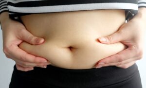 person holding belly fats