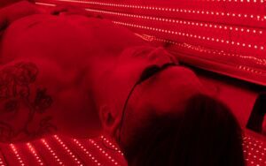 Sculptology - man in red light therapy
