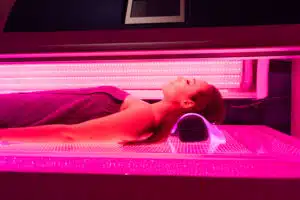 Woman getting led light therapy treatment at Sculptology