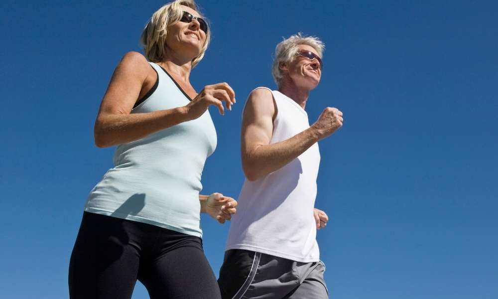 Older couple running to maintain longevity and wellness at Sculptology, California.