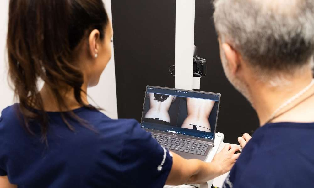 Sculptology staff member showing real CoolSculpting before and after results in California.