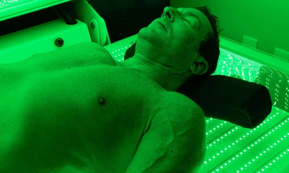 Man receiving Green Light Therapy for skin balance at Sculptology San Ramon.