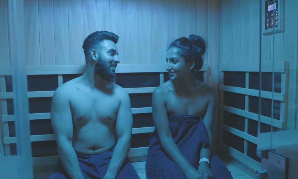 Couple enjoying a dual Infrared Halo Sauna session at our San Ramon wellness center.