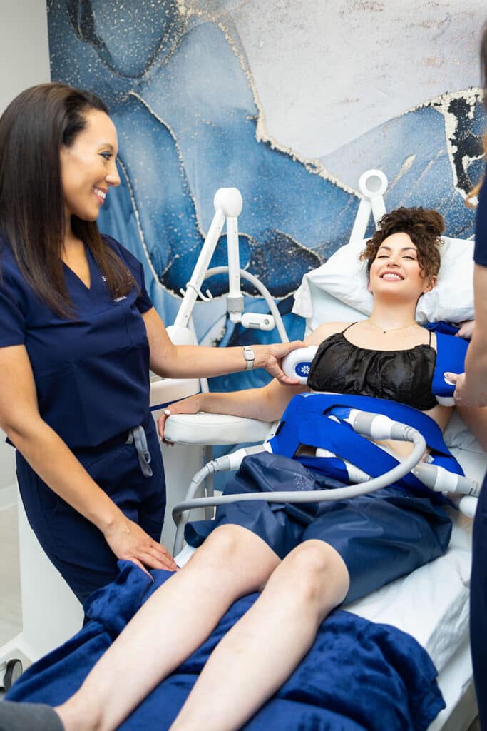 Woman receiving CoolSculpting fat reduction treatment at Sculptology Wellness Center