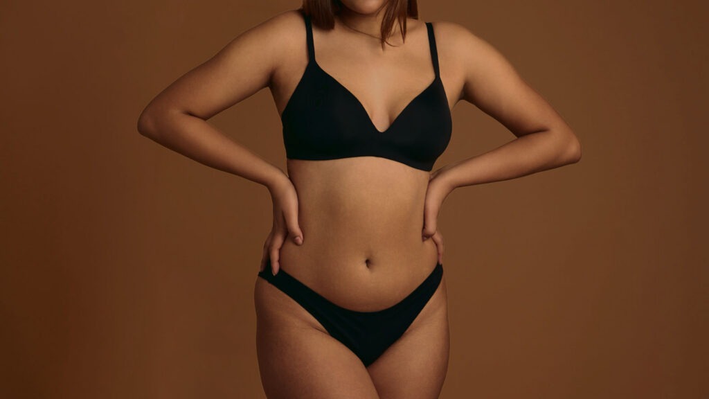 Fitness-minded woman considering CoolSculpting Elite over liposuction